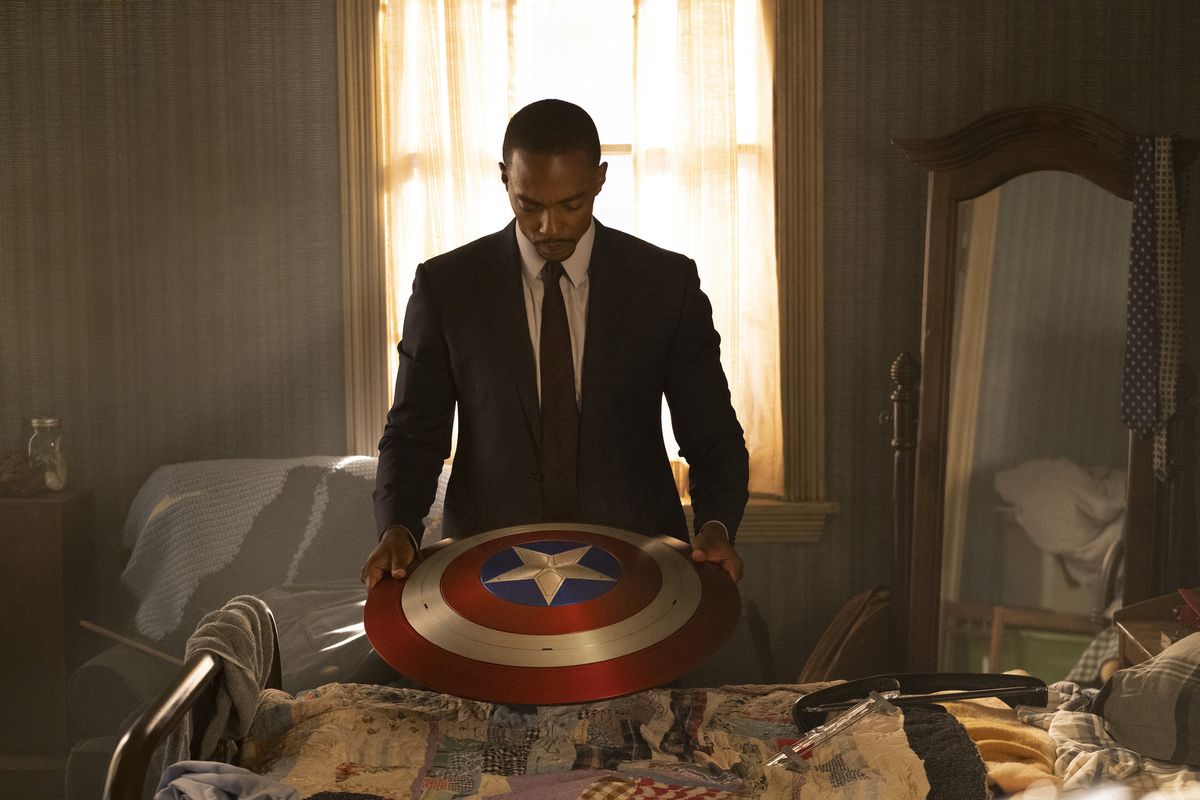 Sam Wilson (Anthony Mackie) looks down at the shield he inherited from Captain America in “The Falcon and the Winter Soldier.”  (Marvel Studios/Disney+)