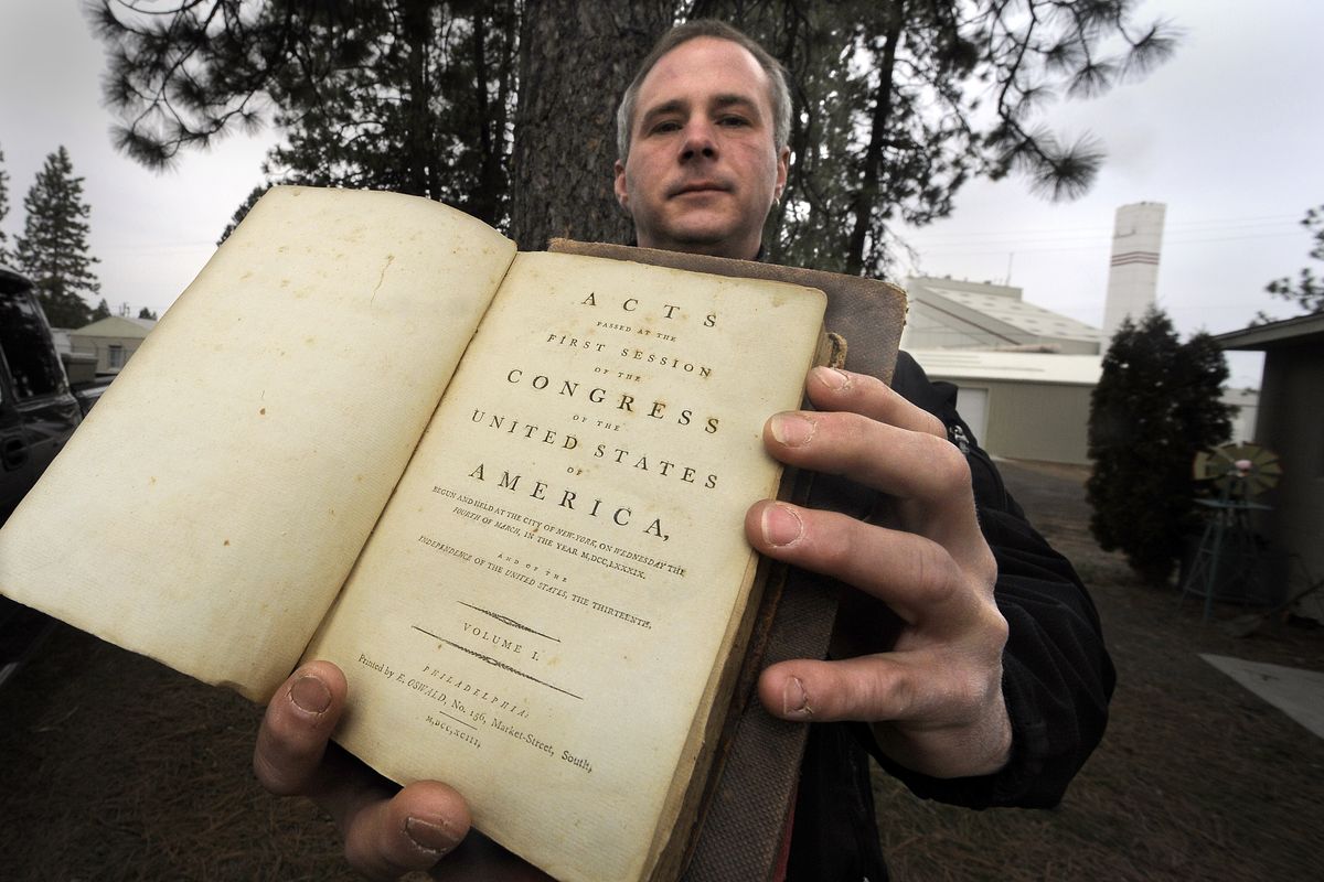 Rick MacKinnon was removing junk from a property when he came across a musty pile of books and documents, including this edition of the laws passed by the first Congress. The producers of “Pawn Stars” were impressed. (Christopher Anderson / The Spokesman-Review)