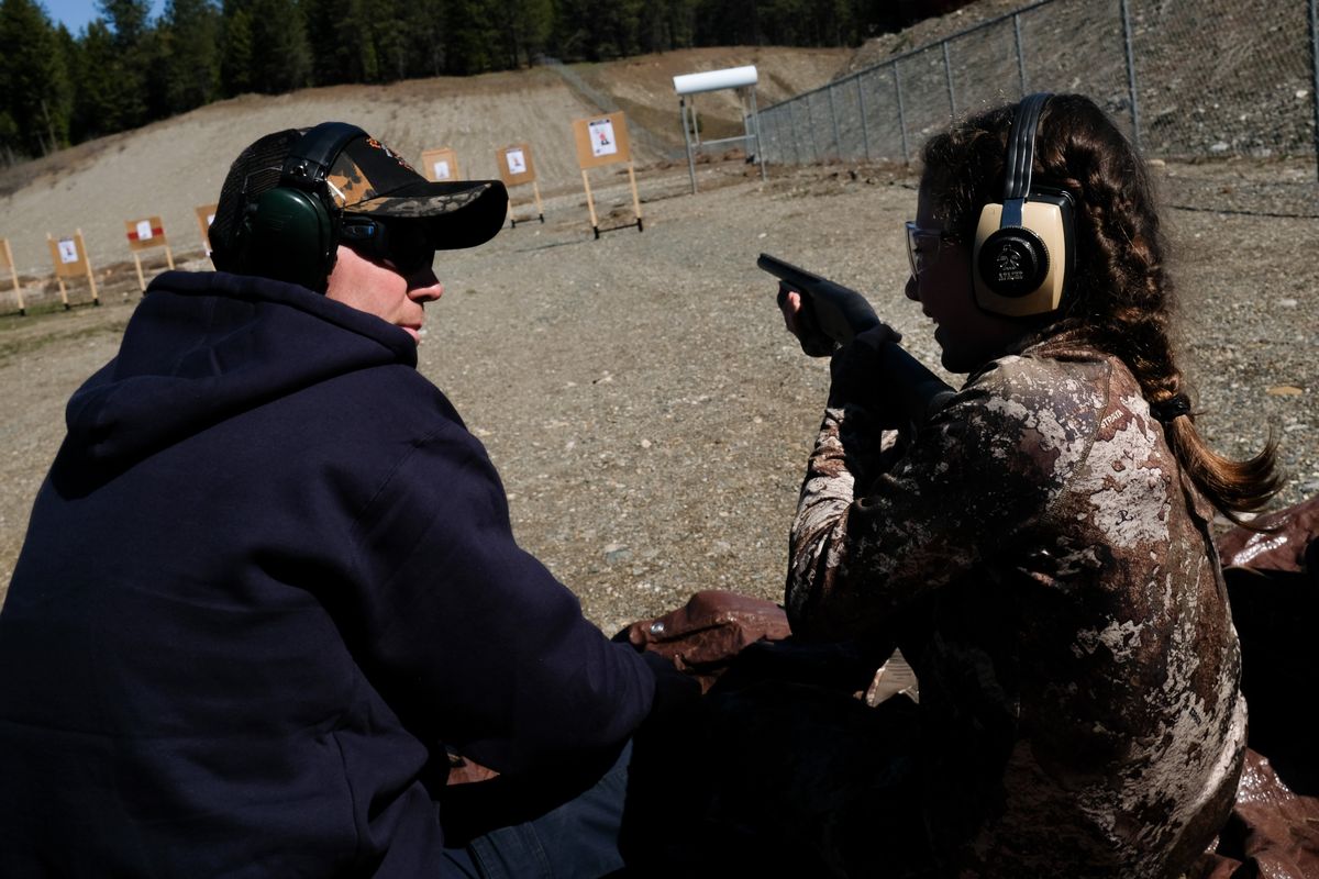 Corinne Holmes, 9, smiles as the First Hunt Foundation’s Grant Samsil mentors her through the fundamentals of safely and effectively handling a shotgun during a mentored spring turkey camp for new hunters on Friday, Apr 22, 2022, in Colville, Wash.  (Tyler Tjomsland/The Spokesman-Review)