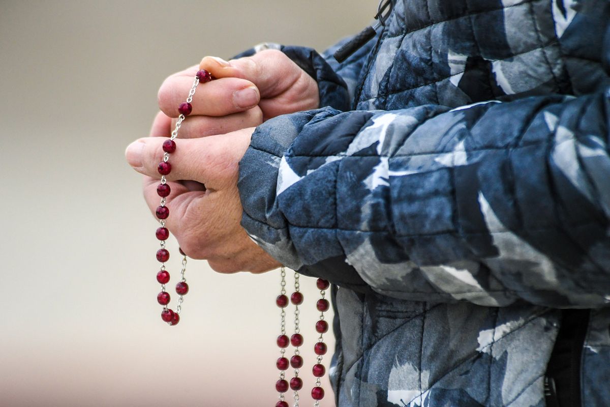 Parishioners hold Rosary beads and pray during a gathering at St. Charles Catholic Church, Friday, March 26, 2021, in Spokane. The service was to pray for the parish following last week’s arson fire at the school building  (DAN PELLE/THE SPOKESMAN-REVIEW)
