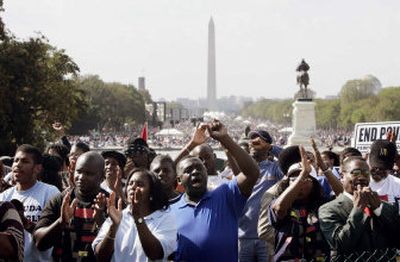 
People cheer during activities on the National Mall for the Millions More Movement in Washington on Saturday. Thousands gathered to mark the 10th anniversary of the Million Man March and focus on the problems faced by the country's poor.  
 (Associated Press / The Spokesman-Review)