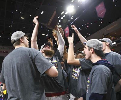 Gonzaga center Przemek Karnowski hoists the WCC tournament championship trophy after Tuesday’s win over Saint Mary’s. (Dan Pelle / The Spokesman-Review)