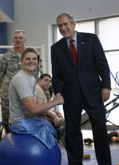 
President Bush greets Army Sgt. Brandon Adam, of Sandpoint,  at a physical therapy lab for wounded soldiers at the Center for the Intrepid at the Brooke Army Medical Center in San Antonio on Nov. 8. Associated Press
 (File Associated Press / The Spokesman-Review)