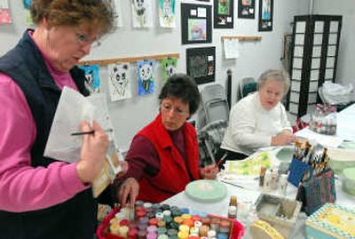 
Joann Ritchie, Barbara Swanson and Linda Harms talk about patterns and paints during a meeting  March 14 of the Evergreen Memory Box Artists. The group   decorates boxes that are given to bereaved parents  for mementos of a child who dies in the hospital. 
 (JESSE TINSLEY PHOTOS / The Spokesman-Review)