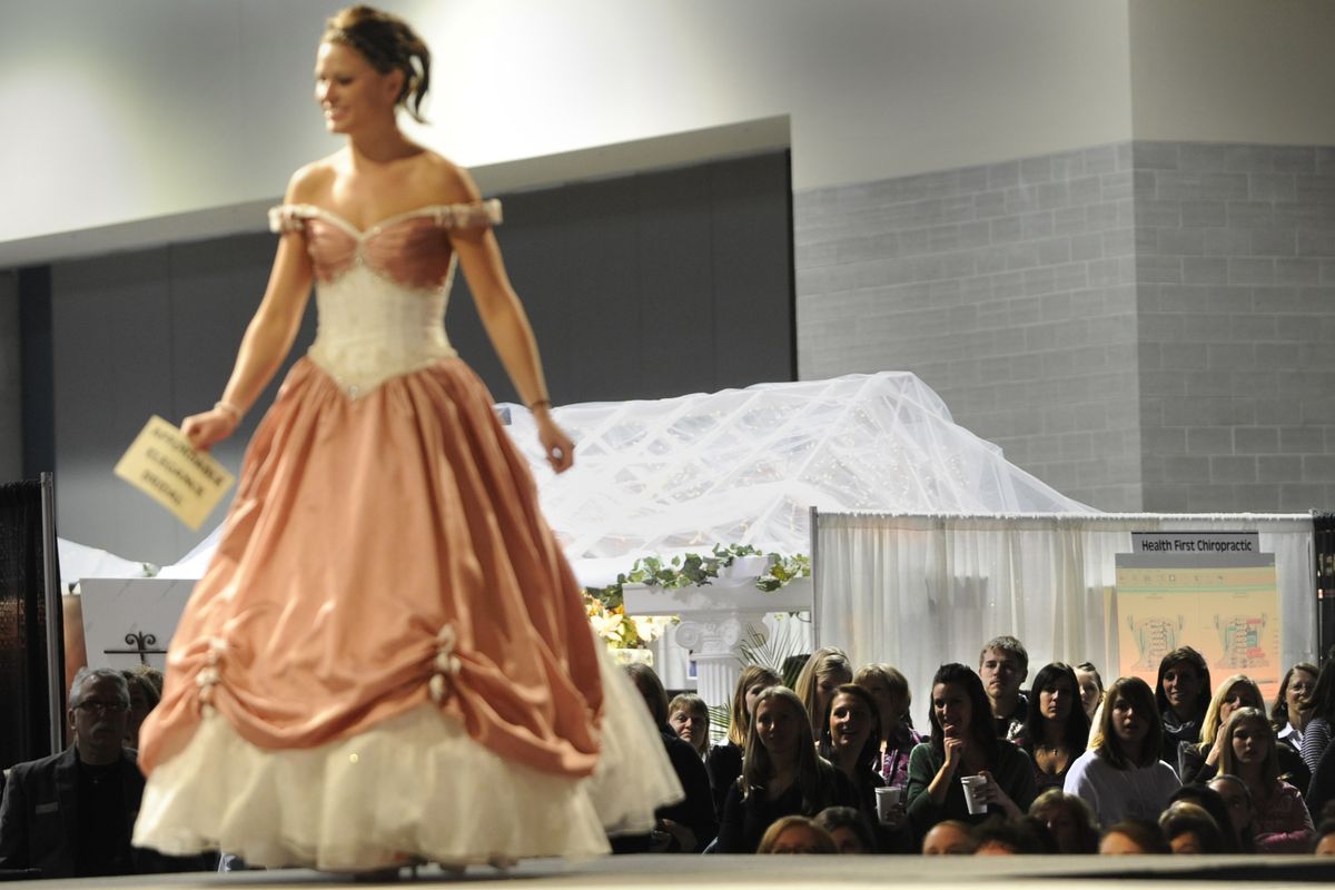 The crowd views wedding fashions  Saturday at the Bridal Festival at the Spokane Convention Center, where photographers, hair salons, cake bakers, bridal boutiques, caterers and limousine services vied for the attention of brides-to-be. (PHOTOS BY JESSE TINSLEY)