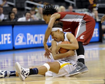 Washington State guard April Cook, top, and California guard Afure Jemerigbe battle for a loose ball during the first half Friday. (Associated Press)