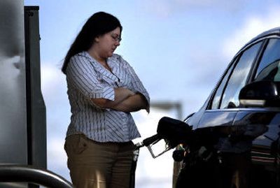 
Stephanie Boutwell waits for her gas tank to fill up at a Citgo 7-Eleven at the corner of Division and Second Avenue in Spokane on Monday afternoon. 