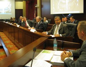 As the state Land Board meets on Tuesday morning, Gov. Butch Otter, center, asks a question of state Lands Director Tom Schultz, right. (Betsy Russell)