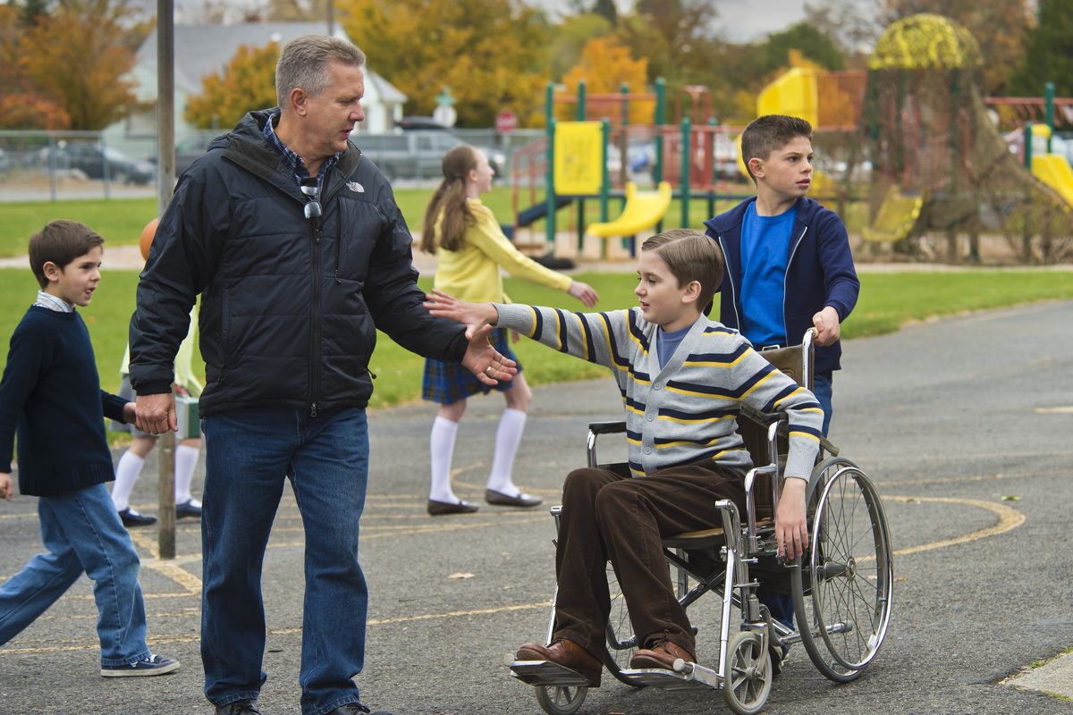 Lyle Hatcher, co-writer and co-director of “Different Drummers,” congratulates actors Ethan Reed McKay, as David Dahlke, and Brayden Tucker, right, playing Lyle Hatcher, as they wrap up a scene on the playground at Pratt Elementary School on Sunday in Spokane Valley. (Dan Pelle)