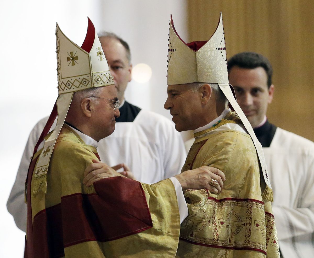 Salvatore J. Cordileone, right, is embraced by Archbishop Carlo Maria Vigano, Vatican Ambassador to the U.S. during a ceremony to install Cordileone as the new archbishop of San Francisco at the Cathedral of St. Mary of the Assumption in San Francisco, Thursday,  Oct. 4, 2012. (Marcio Sanchez / Pool Ap)