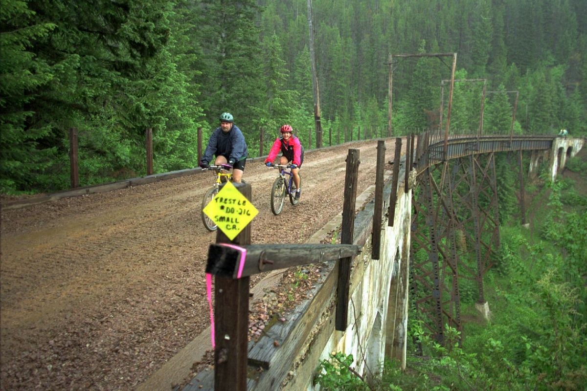 Bicyclists cross a trestle  over Small Creek, along the Route of the Hiawatha Rail Trail. (File Associated Press)