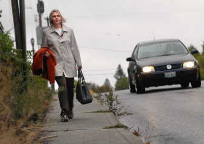 
Shannon Jordan heads downtown to work from her home on Spokane's South Hill on Tuesday. Since her car was stolen, she's been walking the 13 blocks. 
 (Brian Plonka / The Spokesman-Review)