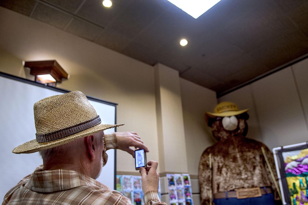 “I bought a 14-inch talking Smokey Bear at a garage sale in 1984,” said Steve Brenger of Copalis Beach, Washington, as he takes pictures during the Smokey Bear Association Convention at The Coeur d’Alene Resort in Coeur d’Alene, on Tuesday, April 19, 2016. (Kathy Plonka / The Spokesman-Review)