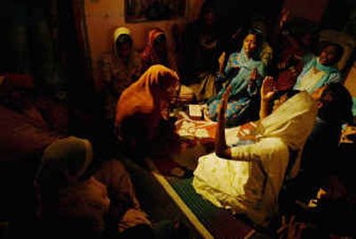 
Relatives of an Indian hostage in Iraq pray Saturday in their home in India.
 (Associated Press / The Spokesman-Review)