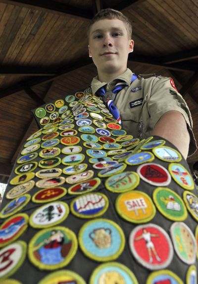 Devon Erickson, a 17-year-old Eagle Scout, holds his double sash holding the merit badges he has earned Saturday. (Jesse Tinsley)