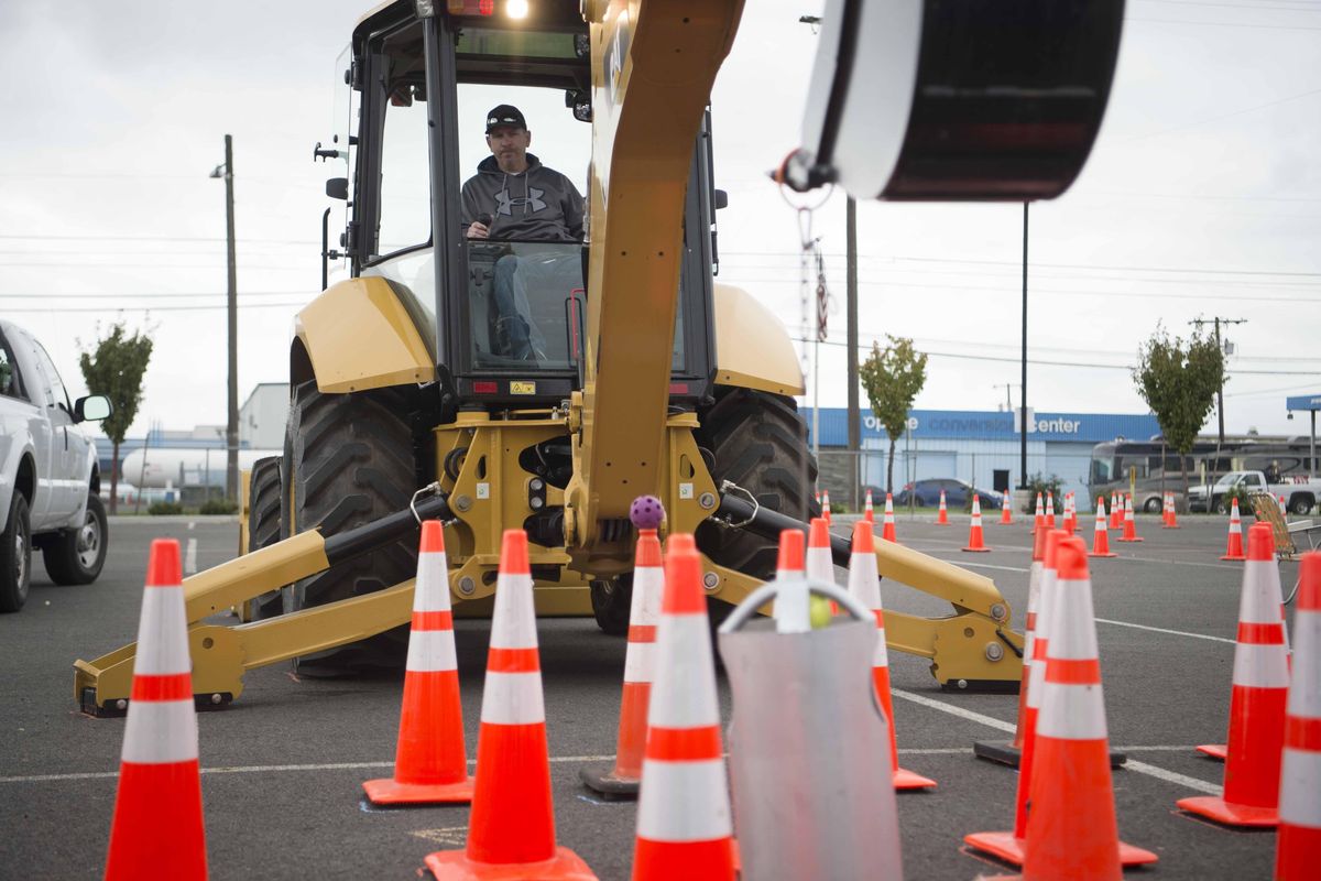 Russ Gordon, who works for the City of Kirkland, navigates an obstacle course with a backhoe during the American Public Works Association