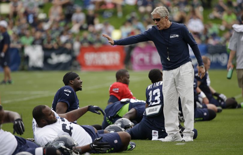 Seattle Seahawks head coach Pete Carroll has plenty of players to direct while waiting for Kam Chancellor to report to camp. (Associated Press)