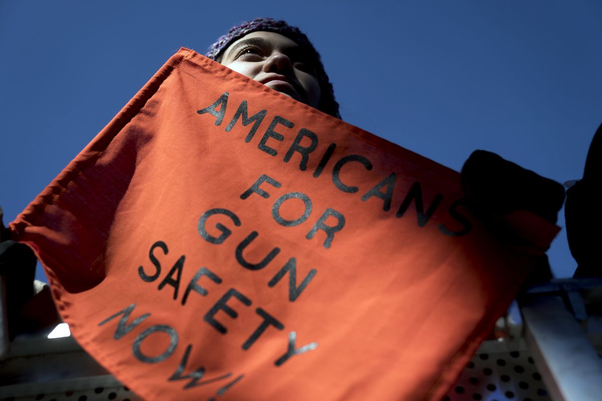 FILE - In this March 24, 2018, file photo, Isabel White of Parkland, Fla., holds a sign that reads "Americans for Gun Safety Now!" during the "March for Our Lives" rally in support of gun control in Washington, that was spearheaded by teens from Marjory Stoneman Douglas High School after the 2018 mass shooting in Parkland, Fla. President Biden faces an uphill battle as he tries to push for more state laws that would allow authorities to temporarily disarm people who are considered a danger to themselves or others. State lawmakers, governors of both parties and former President Donald Trump embraced the so-called red flag laws after the 2018 mass shooting in Florida.  (Andrew Harnik)