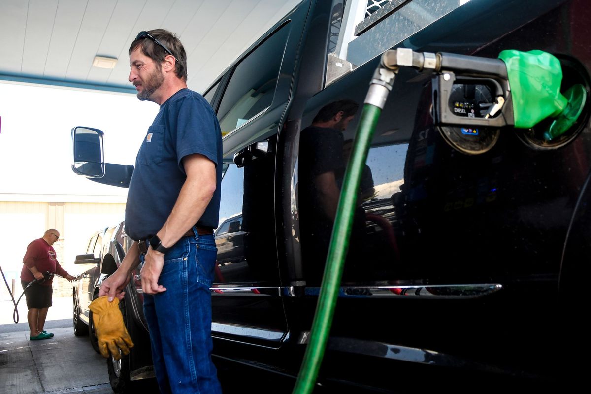 Davenport resident Brett Emmert fills his tank at Maverick Adventure’s First Stop in Post Falls on Thursday. Many Washington residents have opted to cross the border into Idaho to pay for cheaper gas.  (Kathy Plonka/The Spokesman-Review)