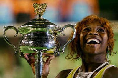 
Serena Williams holds the trophy following her women's singles final victory.  
 (Associated Press / The Spokesman-Review)