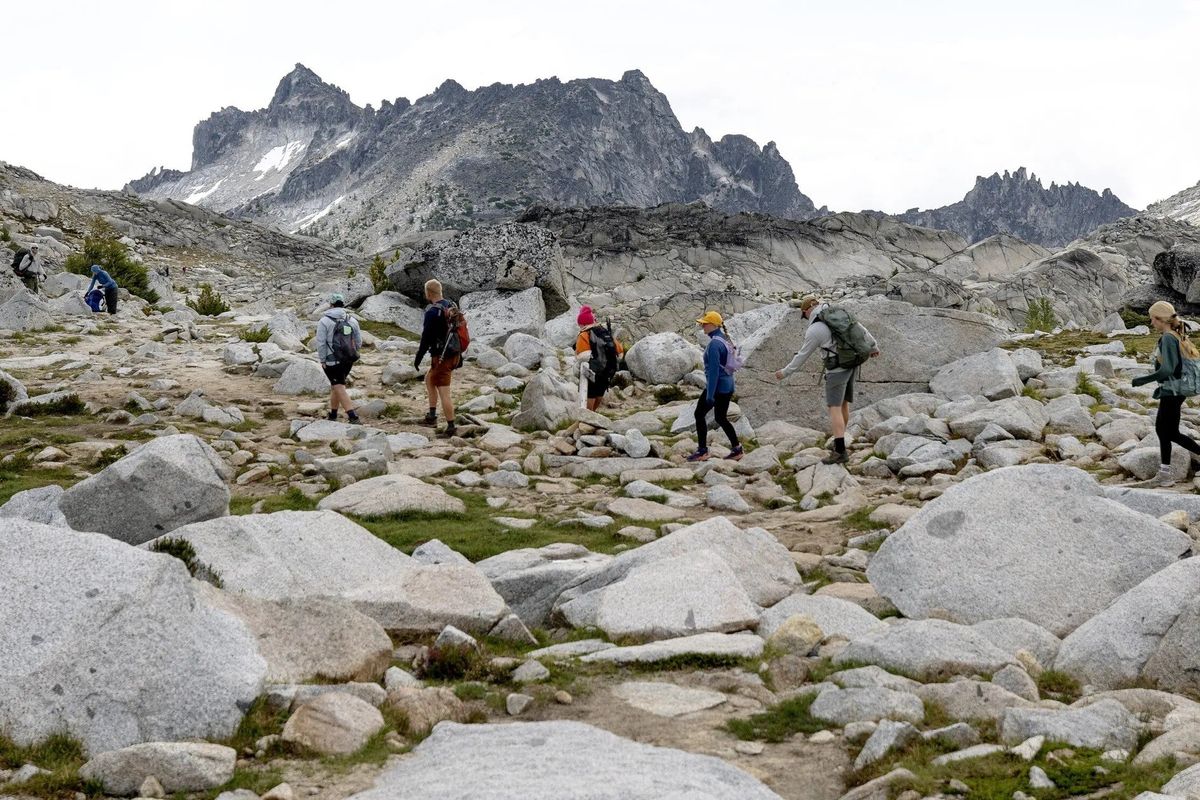 People hike through the Enchantments core zone during the summer of 2025. An estimated 2,400 people visited the area on one day during the July 4 weekend.  (Nick Wagner/Seattle Times)