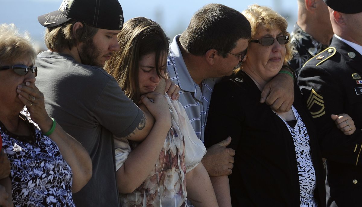Kristie Suprenant, second from right, is comforted by friends and family members as her son’s flag-draped coffin is delivered at Sandpoint Airport on Friday. Her son, U.S. Army Spc. Ethan J. Martin, was killed by enemy fire in Afghanistan on August 7. (Kathy Plonka)