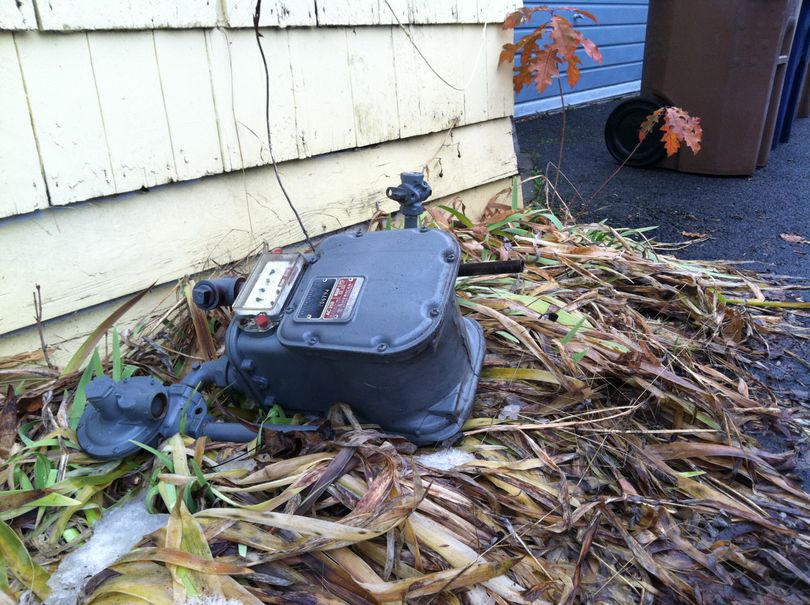 A broken gas meter led to a quick haz mat situation in north Spokane after a garbage truck broke while picking up trash in the narrow alley near Carlisle Avenue and Lincoln Street.  (Nicole Hensley)