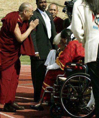 
The Dalai Lama bows to bless Willow Jack and her son, Nakeezaka, 6, not pictured, on Monday. 
 (Associated Press / The Spokesman-Review)