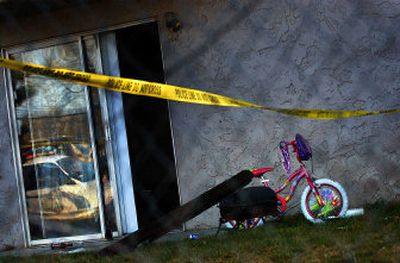 
Police tape hangs around Apartment 1 at 3010 N. Stone St. on Thursday after one man was killed and another was wounded. A butterfly knife was found near the apartment building.
 (Jed Conklin / The Spokesman-Review)