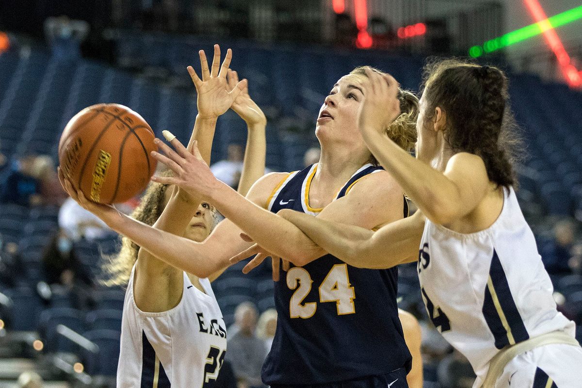 Mead’s Teryn Gardner splits the defense of Arlington’s Samara Morrow, left, and Jenna Villa on a drive during Saturday’s State 3A game for third and fifth places in Tacoma.  (Patrick Hagerty)