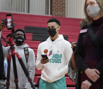 Gonzaga basketball player Jalen Suggs, center, waits for Minnehaha Academy’s Chet Holmgren to announce he will play basketball at Gonzaga during a news conference Monday in Minneapolis.  (David Joles)