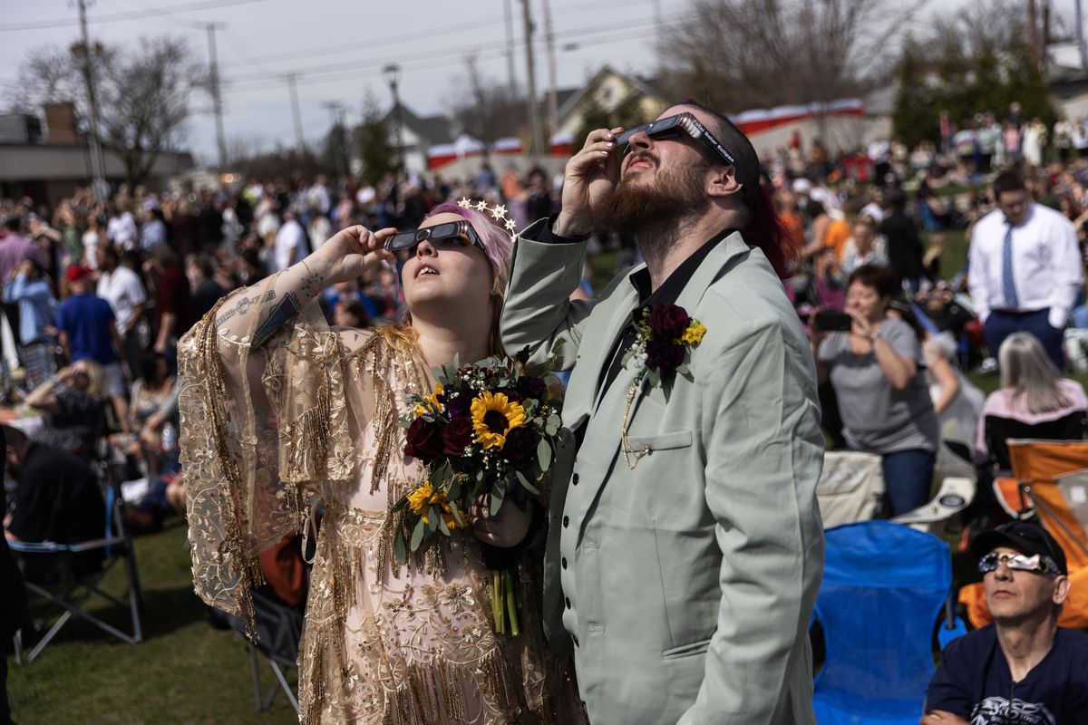People watch the eclipse in Tiffin, Ohio.   (Maddie McGarvey/For The Washington Post)
