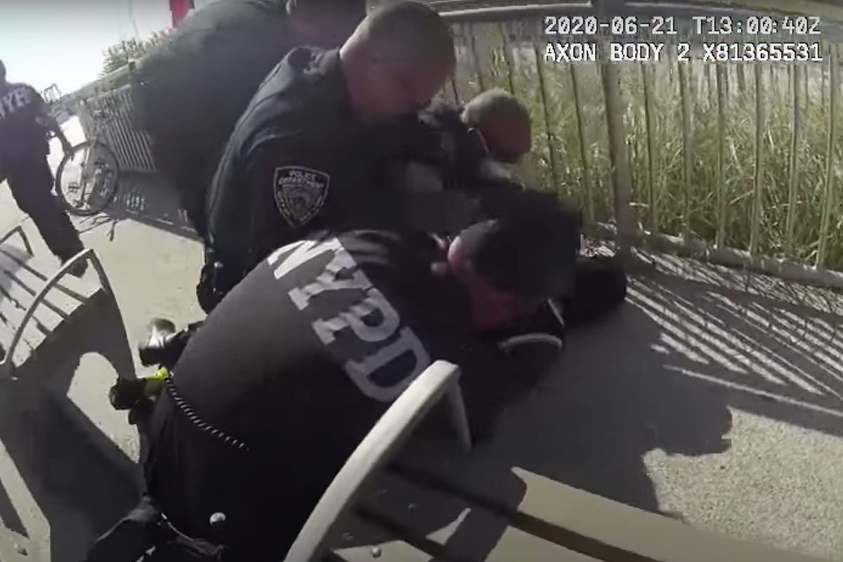 In this photo taken from police body cam video, New York Police officers arrest a man on a boardwalk Sunday, June 21, 2020, in New York. New York City Police Commissioner Dermot Shea says a police officer was quickly suspended without pay after putting his arm around the man
