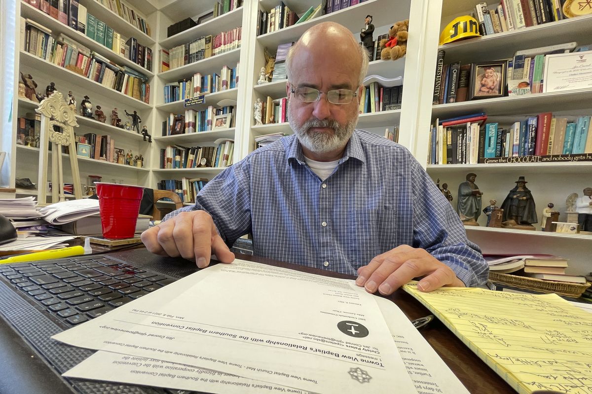 Jim Conrad, pastor of Towne View Baptist Church, looks at a copy of a letter from the Southern Baptist Convention’s credentials committee on Thursday in Kennesaw, Ga. During an SBC meeting, its executive committee will discuss a recommendation Conrad’s church be ousted because it accepted LGBTQ people into its congregation.  (Angie Wang)