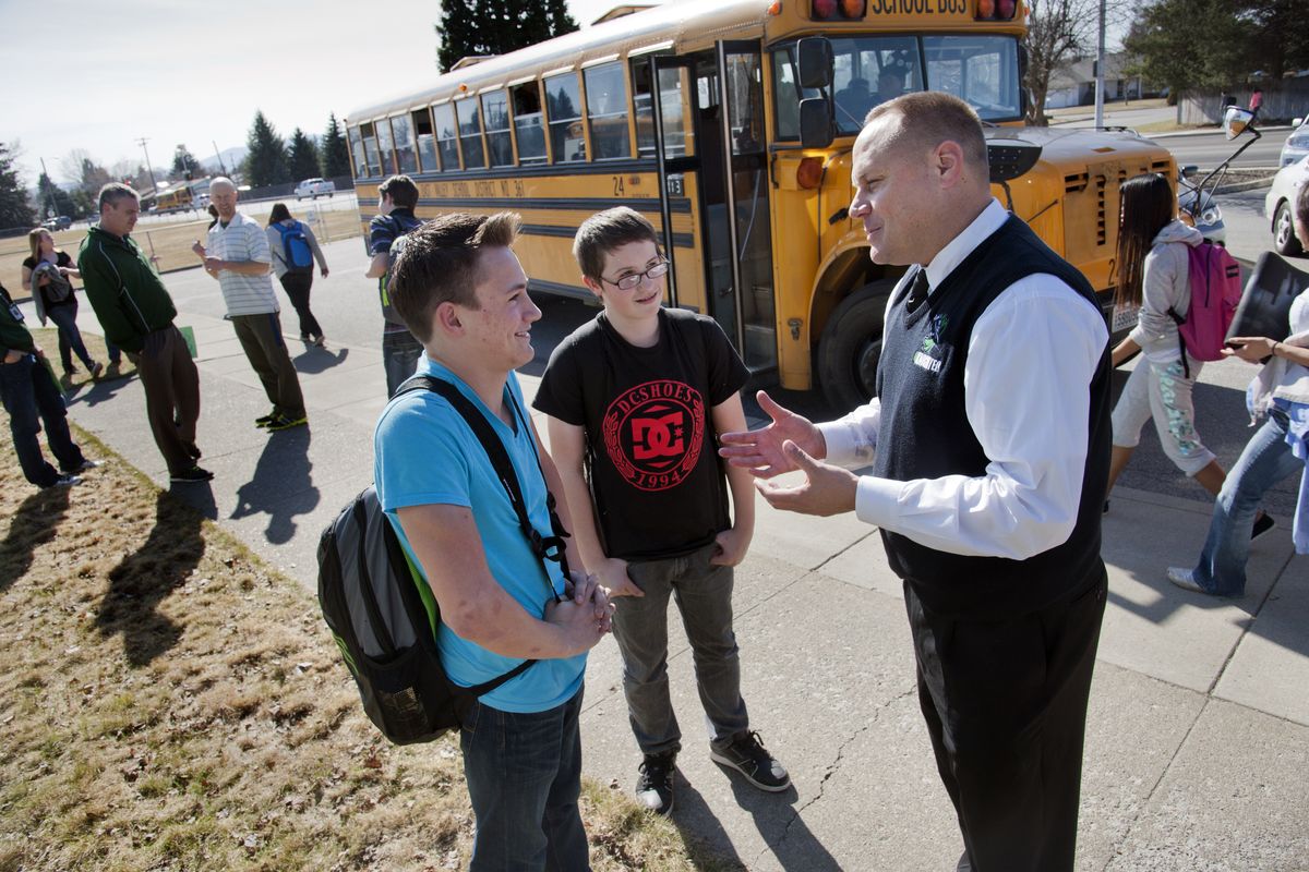 East Valley Middle School Principal Doug Kaplicky helps students to find their correct mode of transportation home after school March 10. (Dan Pelle)