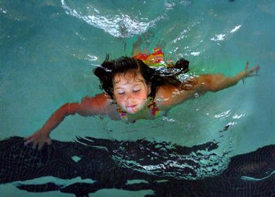
Sidney Skaife, 8, swims in the cool water of the Shadle Park High School pool on Friday. The indoor public pool, the only one of its kind in Spokane, will be torn down in January to make way for the construction of the new Shadle Park High School. 
 (Photos by AMANDA SMITH / The Spokesman-Review)