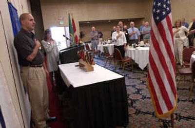 
Valley Rotary president Brad Krueger and member Carrie Stevey lead the club in the Pledge of Allegiance at a meeting at Mirabeau Park Hotel Tuesday. 
 (J. BART RAYNIAK / The Spokesman-Review)