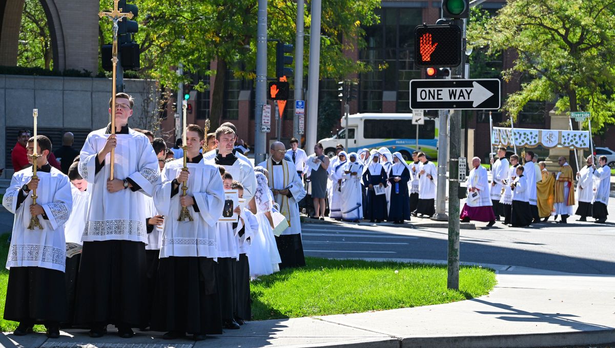 Seminarians and altar servers lead the Eucharistic Expo procession across Main Avenue at Monroe Street, starting from Our Lady of Lourdes Cathedral and heading to the Podium, Sunday, Sept. 10, 2023, in Spokane.  (DAN PELLE/THE SPOKESMAN-REVIEW)