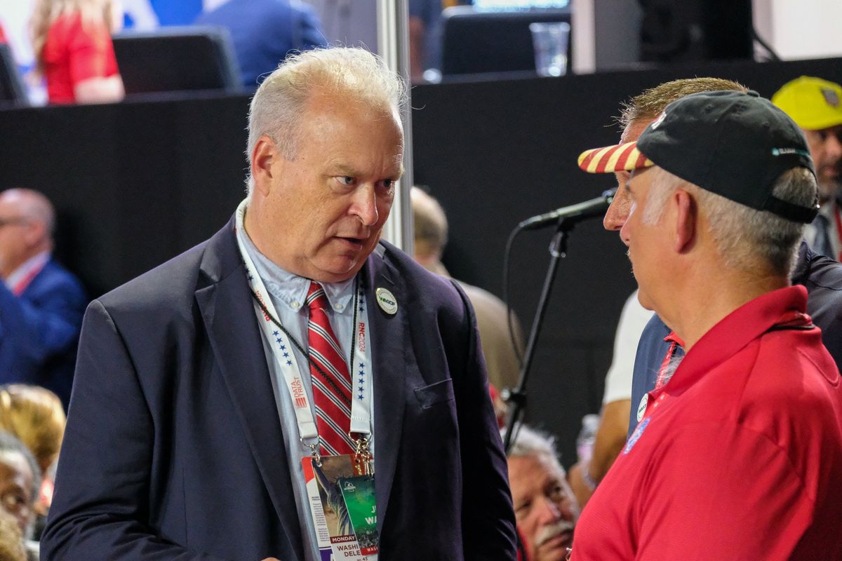 Jim Walsh, chairman of the Washington State Republican Party, speaks to Rob Linebarger, a delegate from Spokane County, at the Republican National Convention in Milwaukee on July 15, 2024. The Washington State Republican Party sent text messages to Spanish-speaking voters on Friday alleging that Democratic candidates want to “eliminate the Spanish language” and “support the chemical castration of your children in school without your knowledge or consent.”  (Orion Donovan Smith/The Spokesman-Review)