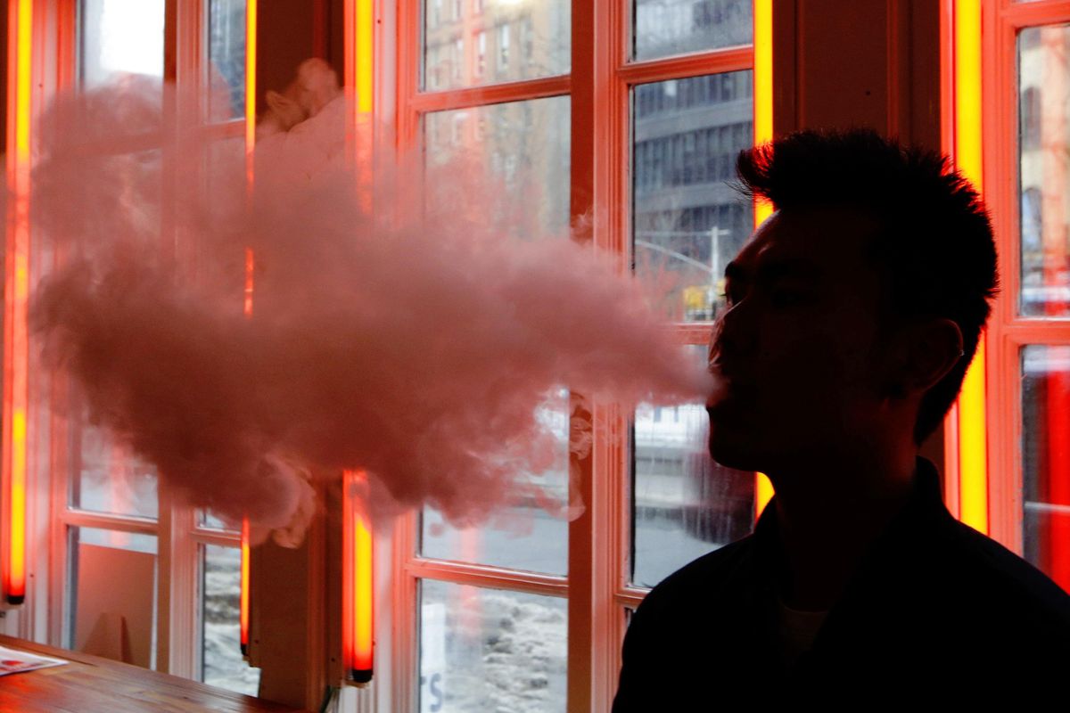 A customer exhales vapor from an e-cigarette at a store in New York on Feb. 20, 2014. (Frank Franklin II / AP)