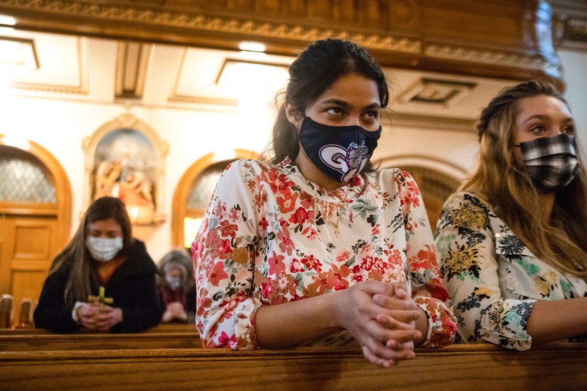 Gonzaga University junior Meredith Perez prays during a morning Palm Sunday service at St. Aloysius that coincided with Gonzaga
