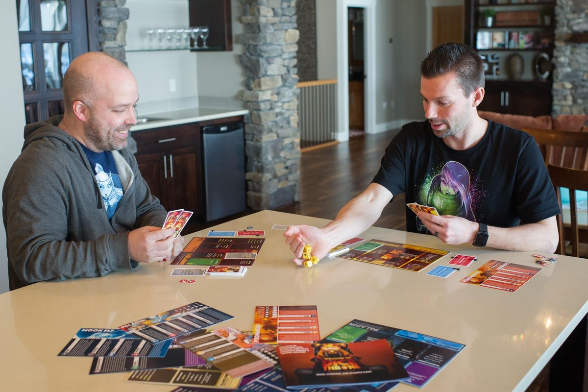 Manny Trembley and Nate Chatellier, right, demonstrate “Dice Throne,” a game they created at Chatellier’s home in Spokane. TYLER TJOMSLAND tylert@spokesman.com (Tyler Tjomsland / The Spokesman-Review)