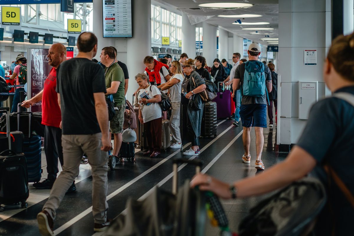 Travelers line up to check in for their flights at Chicago O