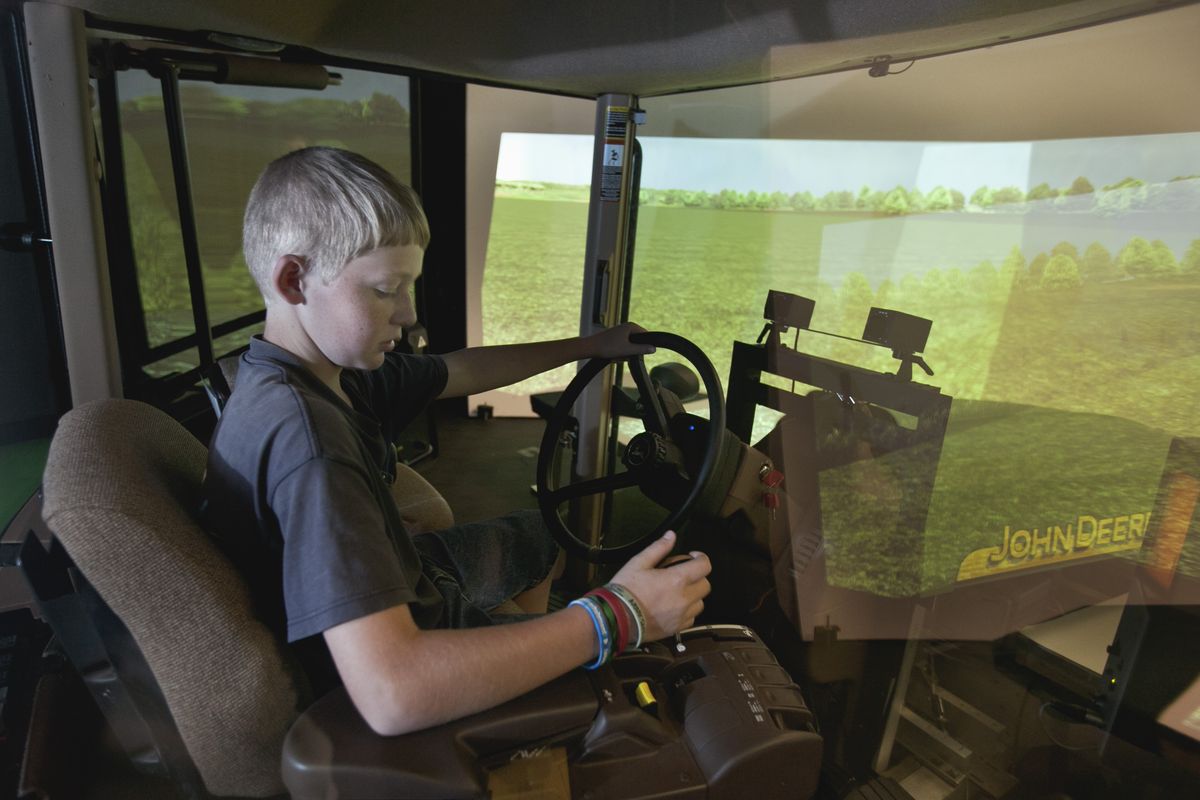 In this Aug. 27, 2012 photo, Mark Gregoricka, 12, operates a tractor simulator in Coralville, Iowa. Scientists at the National Advanced Driving Simulator at the University of Iowa in Coralville this month started what they hope will be a pioneering years long research project that aims to learn how cognitive development affects youth driving performance in tractors. (Nati Harnik / Associated Press)
