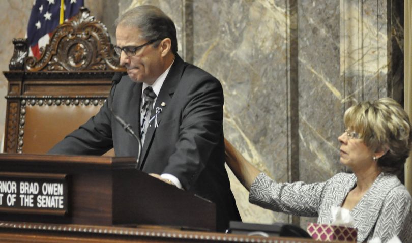 Lt. Gov. Brad Owen is comforted by his wife, Linda, during an emotional part of his announcement in Olympia on Tuesday that he’s retiring from the position after 20 years. (Jim Camden / The Spokesman-Review)