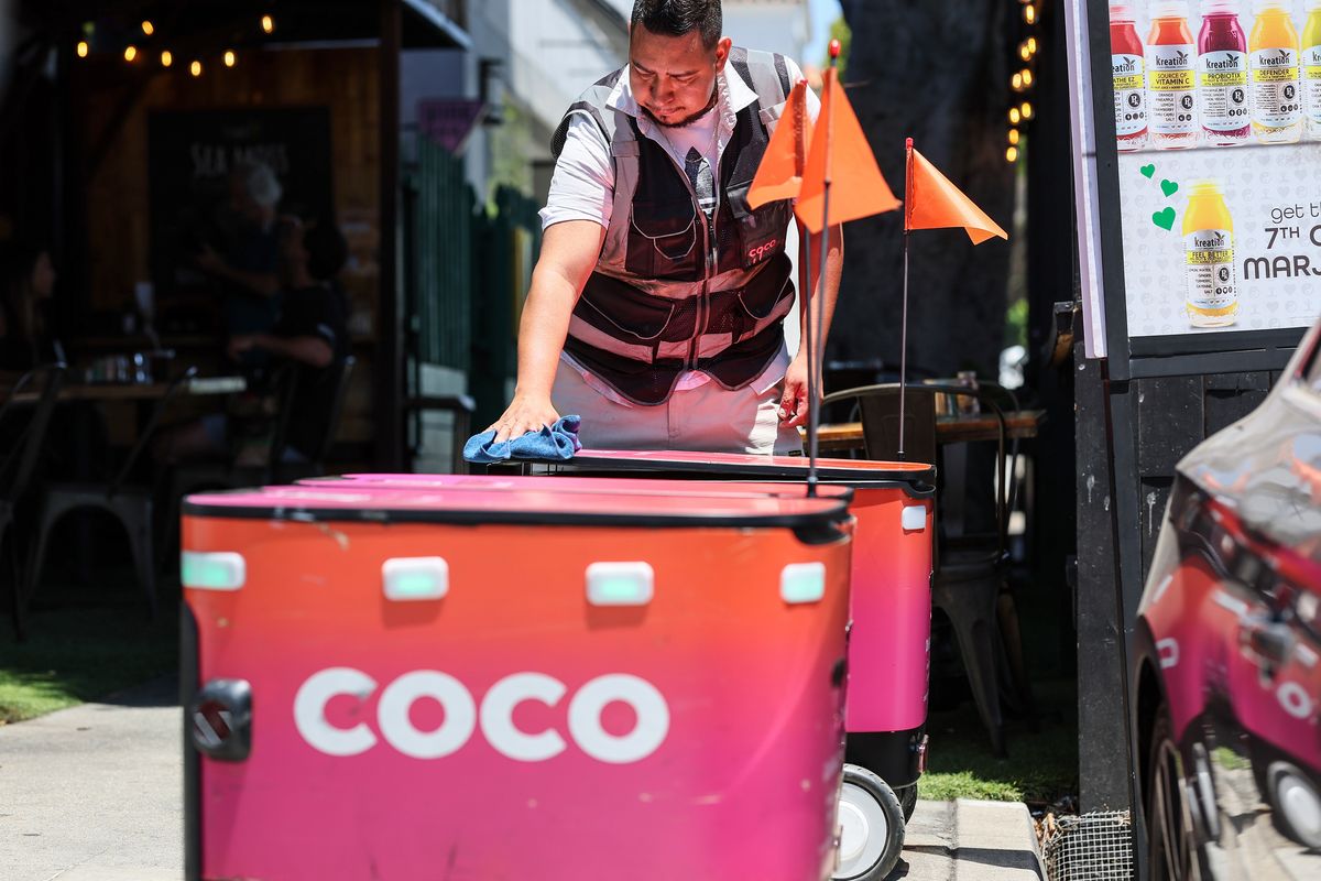 Coco food delivery robot technician Hugo Delgado services units queued up and ready to roll at Kreation Kafe on Wednesday in Santa Monica, Calif. (Robert Gauthier/Los Angeles Times)