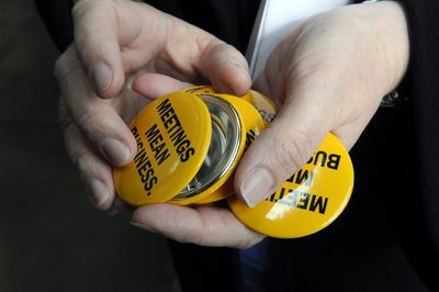 Pam Scott of the CVB passes out buttons at a rally  Friday in River Park Square.  (Dan Pelle / The Spokesman-Review)
