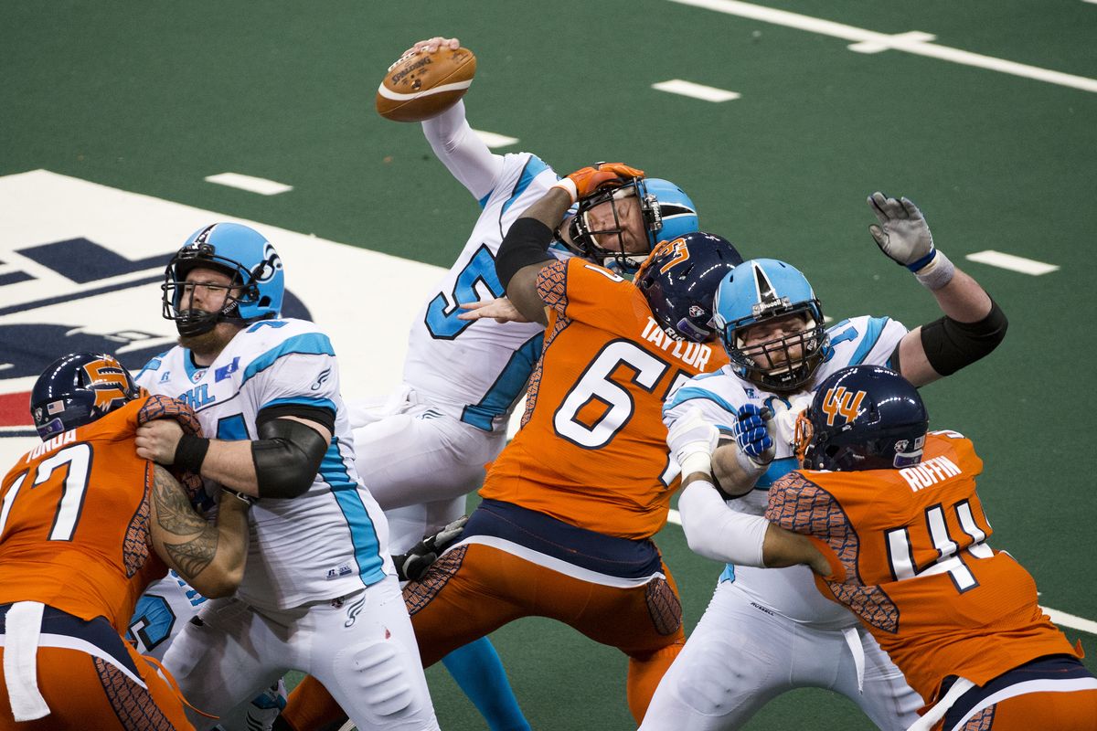 Spokane nose guard Terrance Taylor wraps a paw around Philadelphia quarterback Dan Raudabaugh earlier this season. (Dan Pelle PHOTOS)