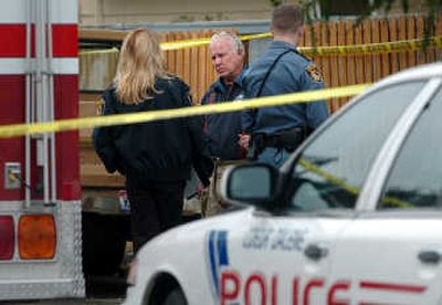 
Glen Lauper, center, talks with Sgt. Christie Wood, left, of the Coeur d'Alene Police at the scene of a fatal fire in 2006.
 (File photo / The Spokesman-Review)