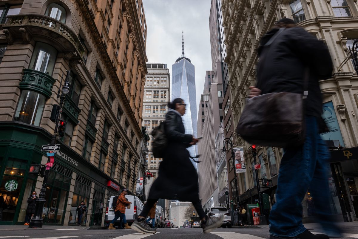 People walk through lower Manhattan moments after New York City and parts of New Jersey experienced a 4.8 magnitude earthquake on Friday. There were no reported injuries in the late morning earthquake, but many people reported visible shaking in buildings and homes. Tremors were felt from Philadelphia to Boston.  (Spencer Platt)